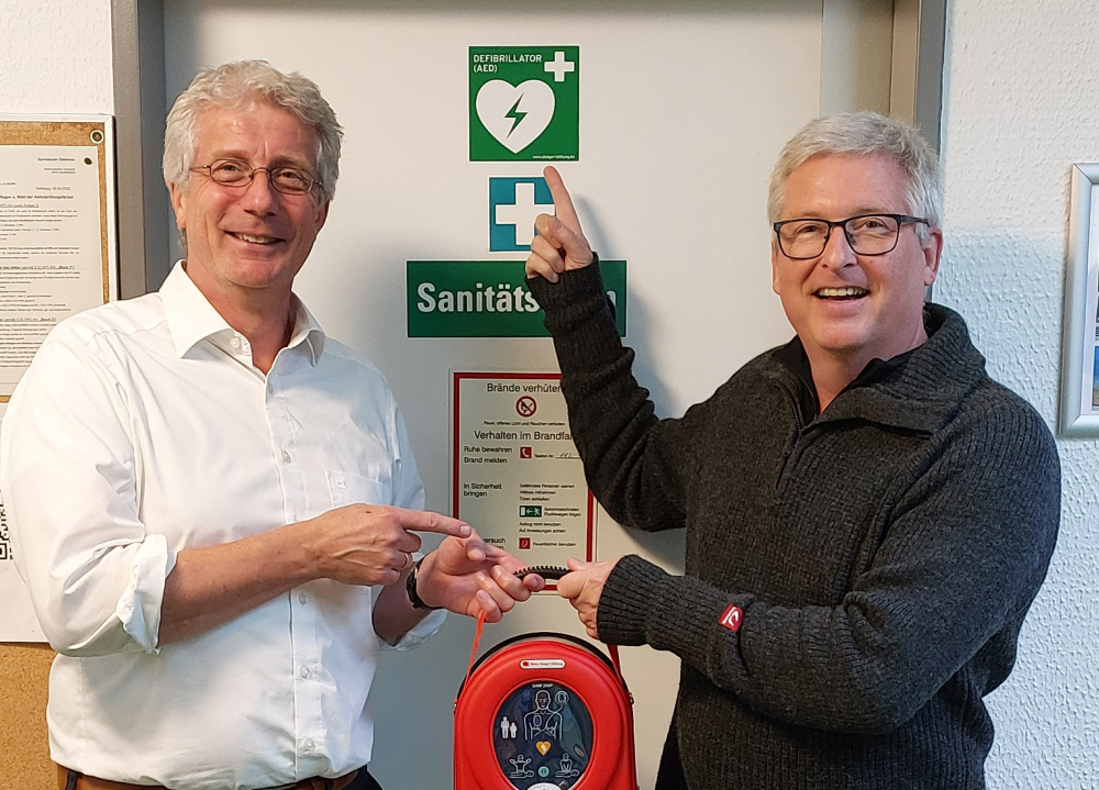 Herr Bendikowski und Herr Schmidt mit Defibrillator
